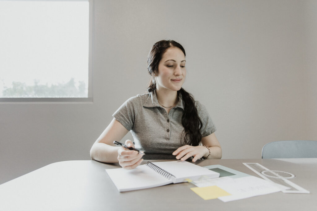 Private pilot student studying for FAA written exam with notes and reference materials